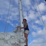 Ivy climbing the mast to flake the sail.